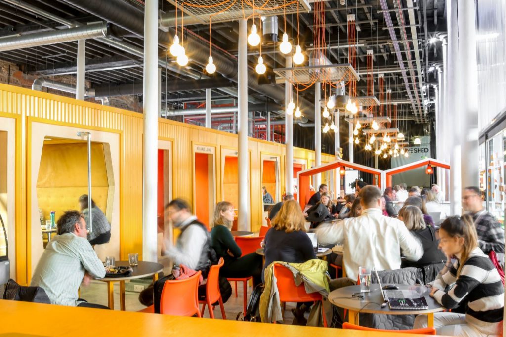 People working in Engine Shed's vibrant lounge