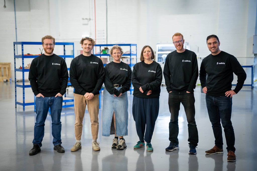 Celltris team - six people in manufacturing space smiling wearing black Celltris jumpers