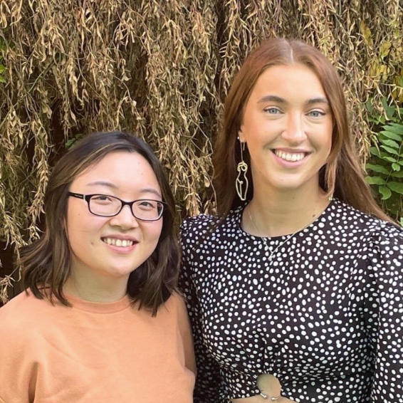 Kira Goode and Monica Wai, Co-founders of Eleria, standing in front of trees, smiling