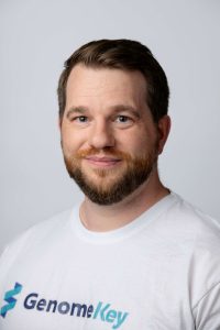 Dr Michael Roberts, CEO of GenomeKey, wearing white company logo t-shirt