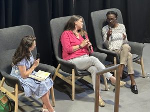 Three women sitting on chairs speaking at a panel event called Startup Stories: Spinout Edition