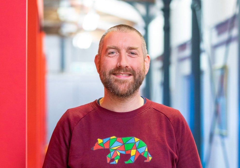 Paul Forster Engine shed, Temple Meads, Bristol. 24 Jan 2023Pic: Jon Rowley Paul Forster in SETsquared Bristol corridor, wearing bear logo on red jumper