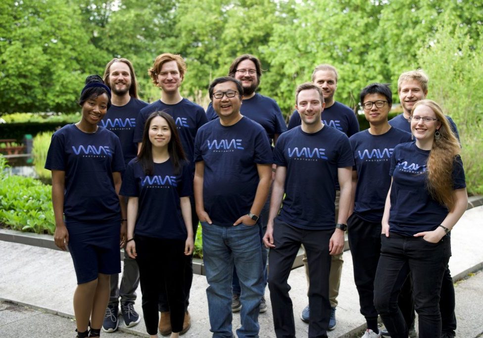 Wave Photonics team, a diverse group of eleven people outside wearing Wave branded t-shirts